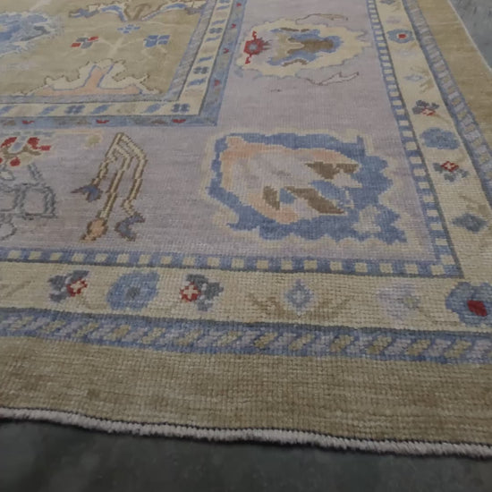 Light olive Turkish Oushak rug with warm ivory border, powder blue floral motifs, soft gray, taupe, and rust accents, hand-knotted wool 10x14 area rug from Indigo Rugs Burlingame Bay Area.