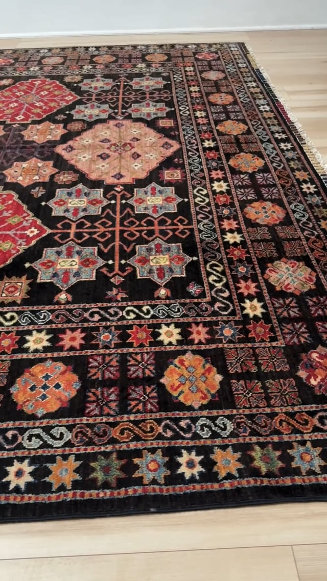 Handmade Turkmen-style 9x12 wool rug with Caucasian-inspired design, rich black, crimson, ivory, and sage hues. Luxury area rug with intricate medallions and floral motifs, perfect for bedroom, living room, or dining room. High-quality craftsmanship from the best rug shop in Burlingame CA, SF Bay Area. Free shipping, timeless character, and elegance for any space.