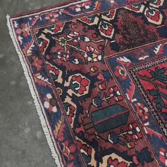 10x13 handmade Persian Bakhtiari vintage rug with garden panel design, floral motifs, and red and navy tones — shown in living room at Indigo Rugs, Burlingame — San Francisco Bay Area with free shipping