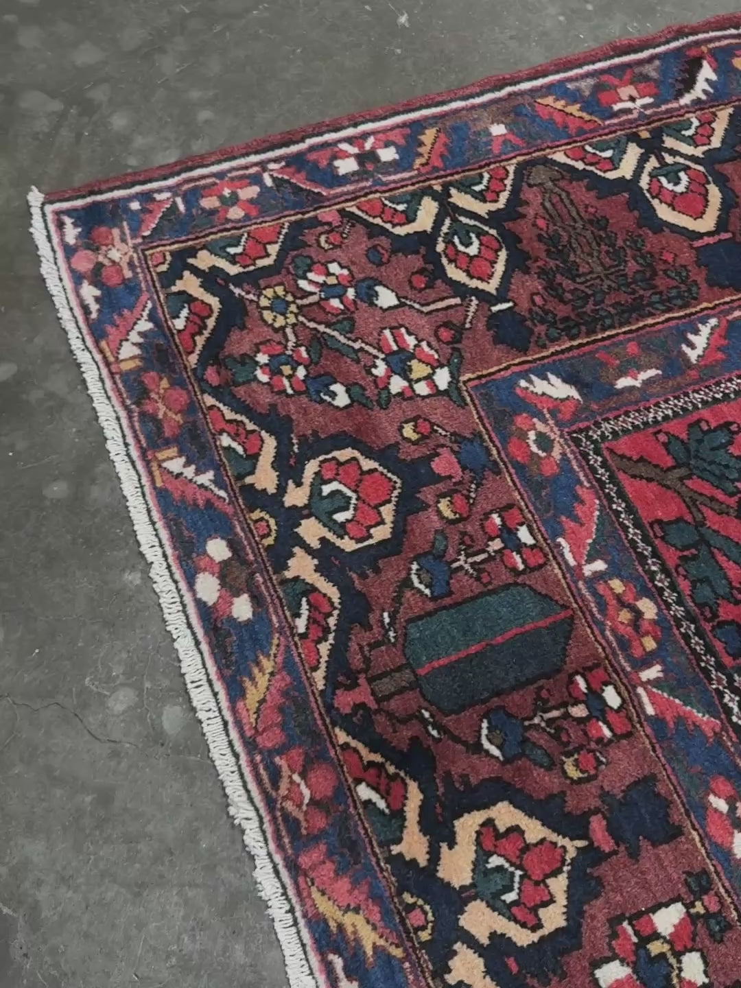 10x13 handmade Persian Bakhtiari vintage rug with garden panel design, floral motifs, and red and navy tones — shown in living room at Indigo Rugs, Burlingame — San Francisco Bay Area with free shipping