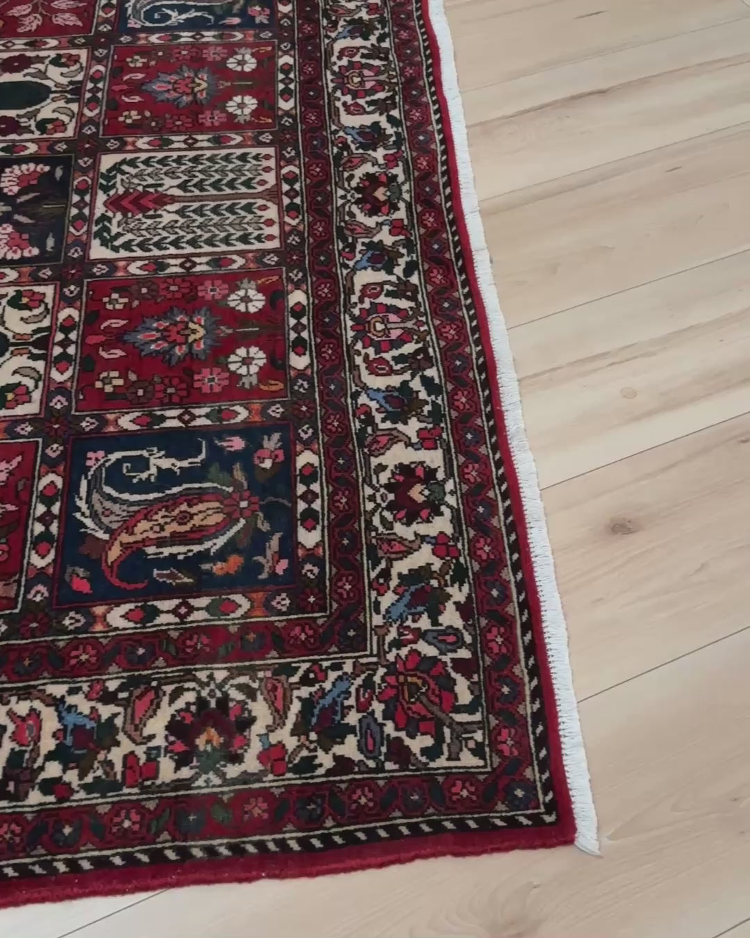 Vintage Persian Bakhtiari rug wit red field, navy garden panels, ivory details, and intricate floral motifs, handmade wool area rug 5x8 from Indigo Rugs Burlingame SF Bay Area