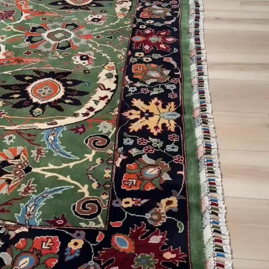 Brand new 9x12 Persian sickle leaf rug with verdant green, navy, and crimson hues, available at the best rug shop in San Mateo, SF Bay Area. Handwoven with intricate floral and vine patterns, perfect for a bedroom, living room, or dining space. High-quality wool rug with rich character and timeless elegance. Free shipping available.