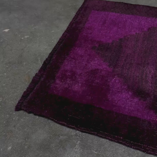 Magenta Purple Turkish mini rug with deep plum purple field, aubergine and blackberry shading, soft magenta border glow, and subtle geometric medallion. Handmade wool rug measuring 18 × 38 inches, perfect for entryways, kitchens, bedside spaces, or layered interiors.