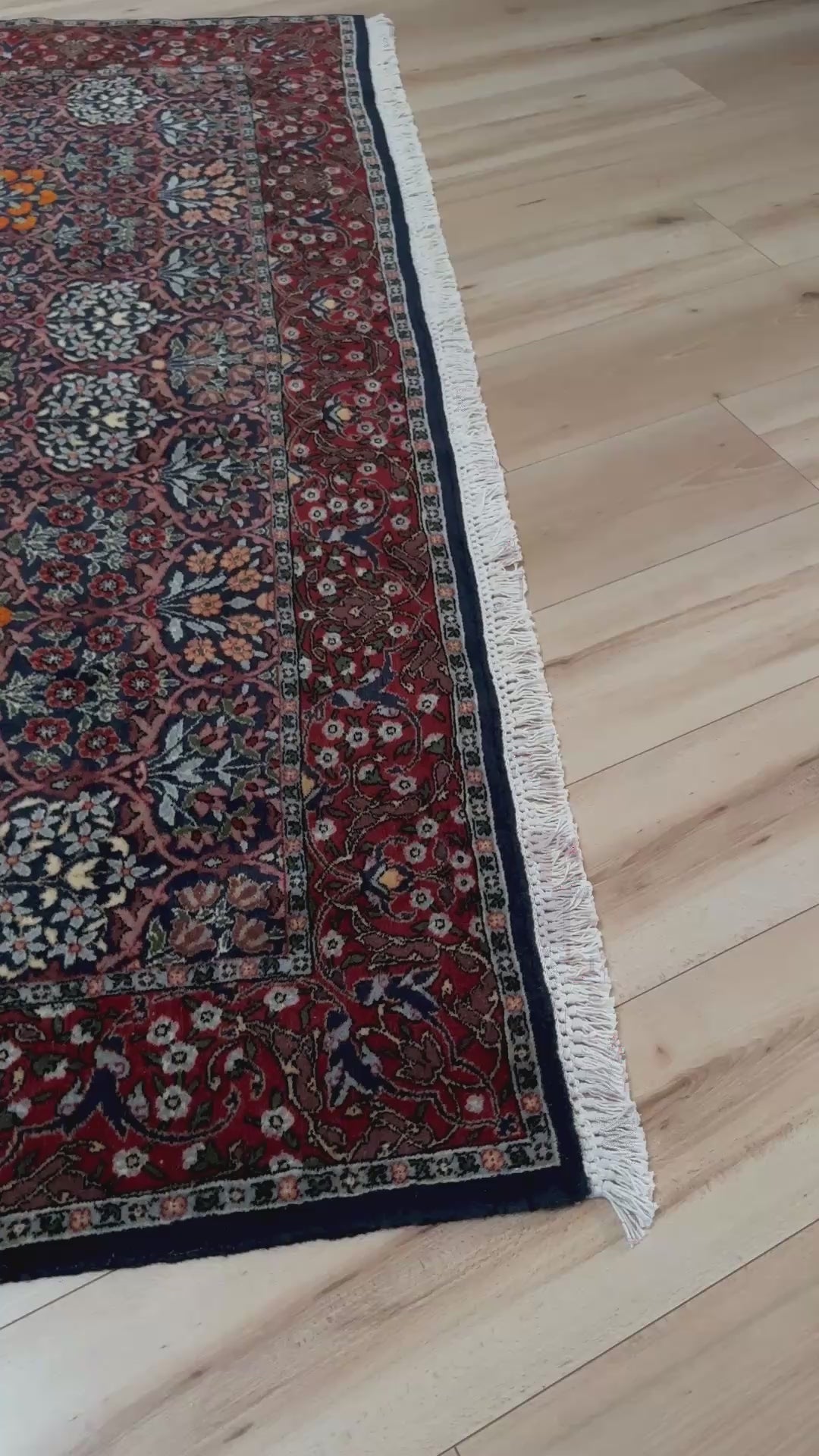 Vintage 1960s 7x9 Watermelon Hereke Turkish floral rug with midnight blue field, maroon border. Perfect for living rooms, dining spaces, or bedrooms. Indigo rug shop in Burlingame, San Francisco Bay Area, CA with free shipping.