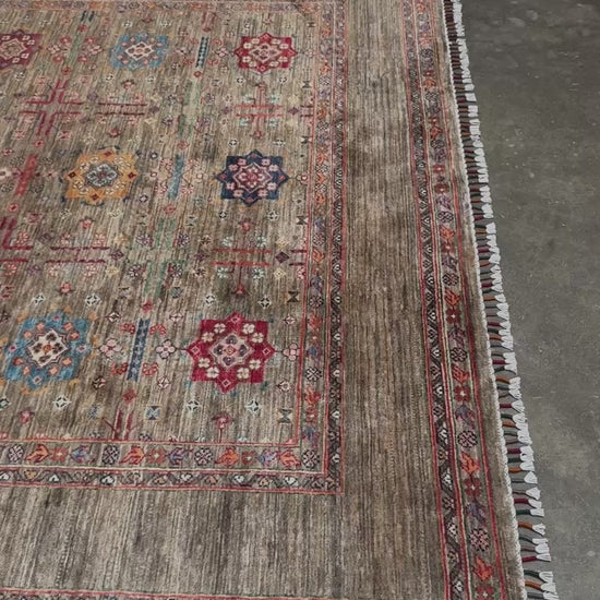 Contemporary Bilcik Turkmen 7x10 rug with dusted olive taupe field, colorful tribal motifs, handmade Ghazni wool area rug from Indigo Rugs Burlingame Bay Area.