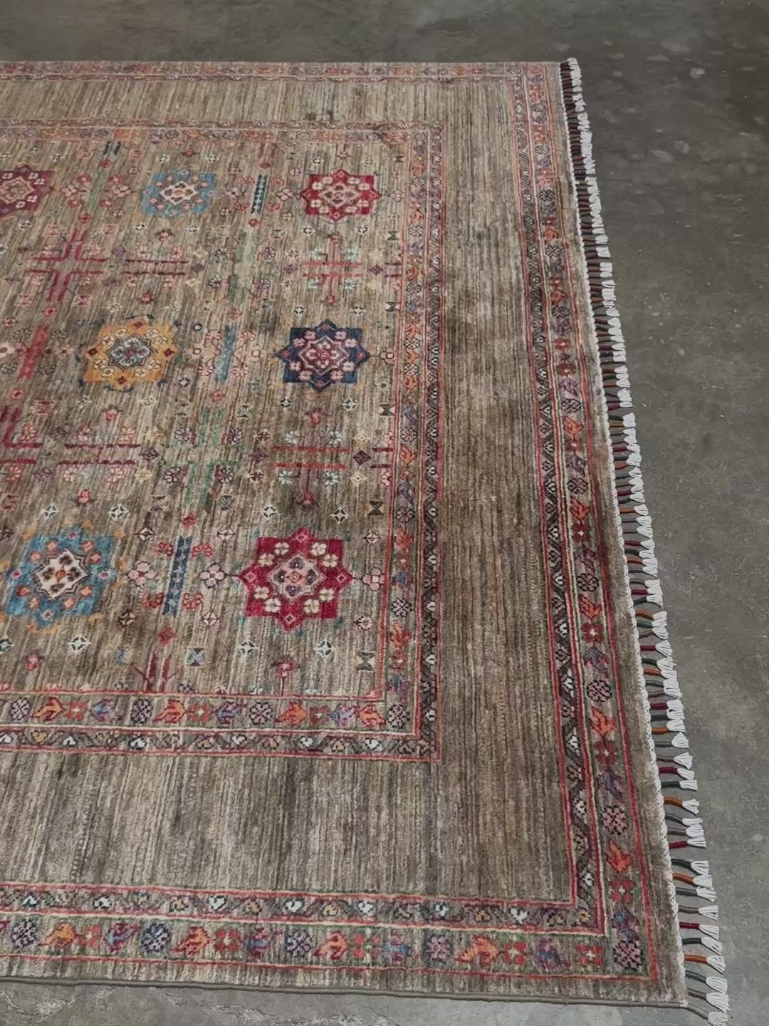 Contemporary Bilcik Turkmen 7x10 rug with dusted olive taupe field, colorful tribal motifs, handmade Ghazni wool area rug from Indigo Rugs Burlingame Bay Area.
