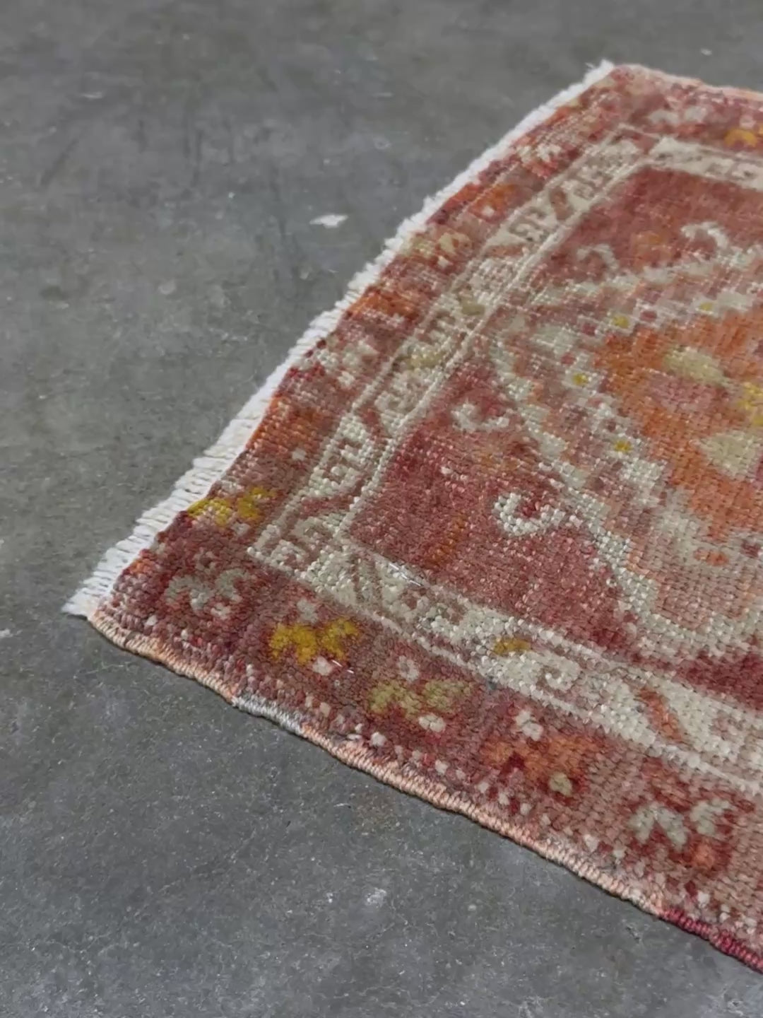 Antique Turkish handmade mini rug with dusty terracotta field, faded peach. Hand-knotted wool, 19x36 inches. Circa 1930s–1950s. Perfect for: Entryways, apartment foyers, beside the bed, kitchen sink areas, bathroom vanity spots. One-of-a-kind piece from Indigo Rugs in Burlingame, the best rug shop in the San Francisco Bay Area. Free shipping included. 