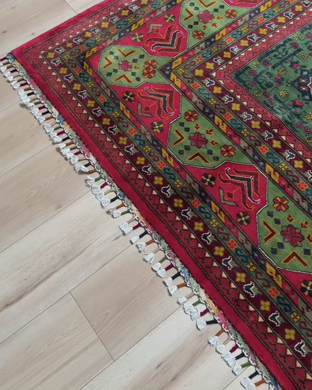 Forest green Bilcik Turkmen rug with cherry red border, geometric tribal motifs, olive green, navy, mustard, burgundy and rust accents, handmade wool 10x14 afrom Indigo Rugs Burlingame Bay Area.