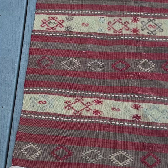 3x6 vintage turkish striped kilim rug with red, white, and black geometric pattern