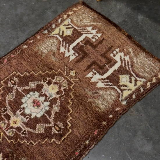 Vintage Turkish mini rug with earthy brown field and soft ivory geometric medallion, hand-knotted wool Anatolian village rug, 19x30 small accent rug for bedside, entryway, or wall art. From Indigo Rugs, Burlingame — San Francisco Bay Area.