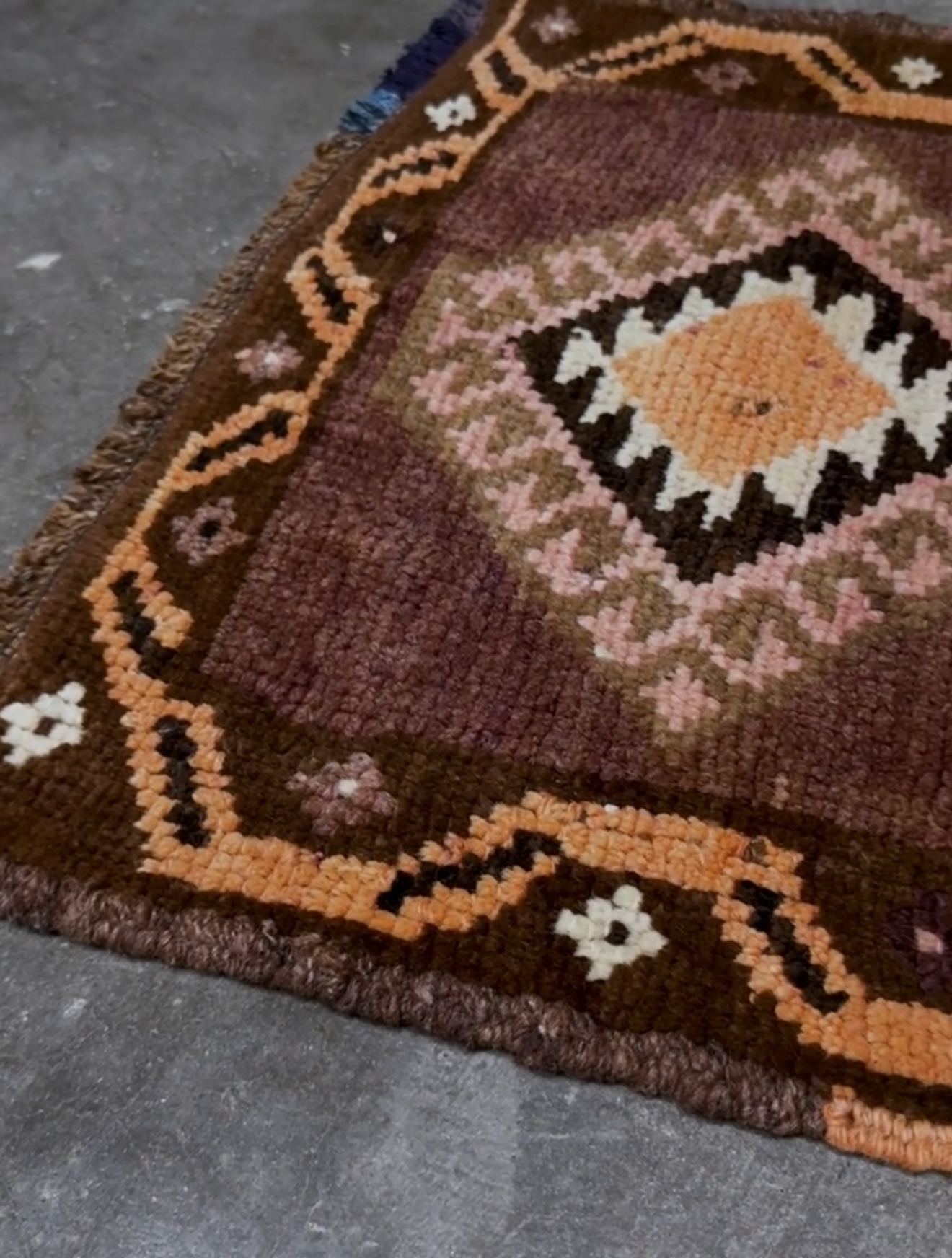 Earthy mauve and brown vintage Turkish mini rug with stacked diamond medallions in peach and ivory, handmade Anatolian Yastik rug 2x3, perfect for entryway or bedside accent, kitchen.