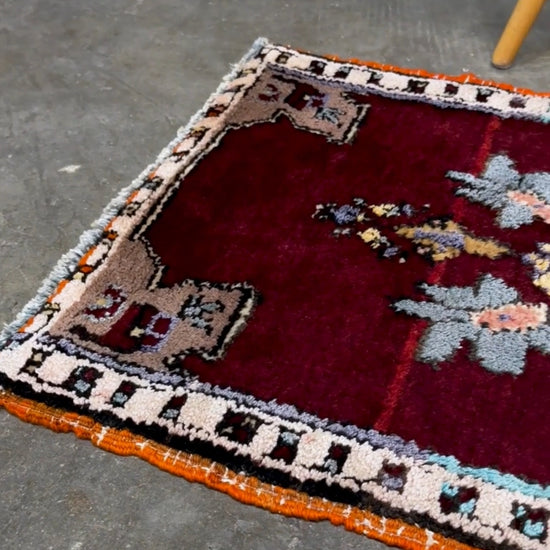 Vintage Turkish Yastik mini rug in ruby red. Hand-knotted wool, 20x33. One-of-a-kind rug from Indigo Rugs, the best rug shop in the San Francisco Bay Area (Burlingame, CA). Free shipping included.