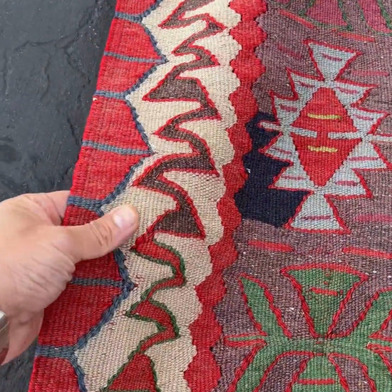 4x10 vintage Turkish Oushak kilim rug with a dusty rose field, geometric tribal medallion, and soft sage, mint, and blue accents — handmade flatweave wool rug from the 1940s, naturally dyed and beautifully aged with mellowed colors and small, well-executed repairs. Perfect for living room or bohemian interior décor — Indigo Rugs.