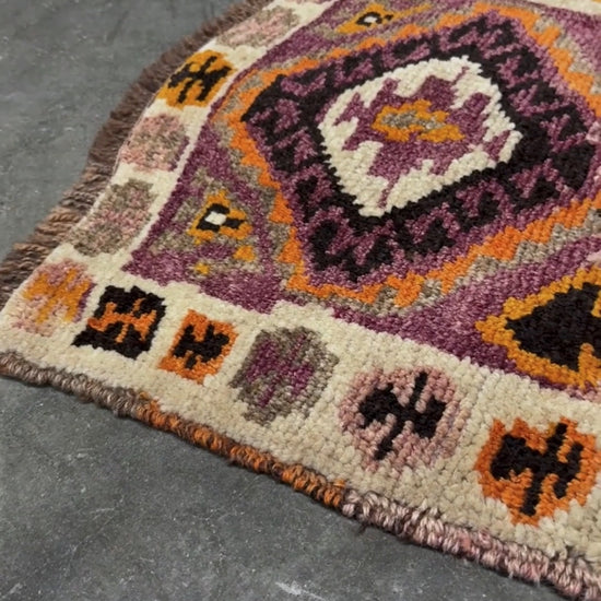 Vintage Turkish Yastik mini rug with earth colors mauve-purple, taupe, and burnt orange. Handmade woxol, 2x3 feet. One-of-a-kind rug from Indigo Rugs, the best rug shop in the San Francisco Bay Area (Burlingame, CA). Free shipping included.