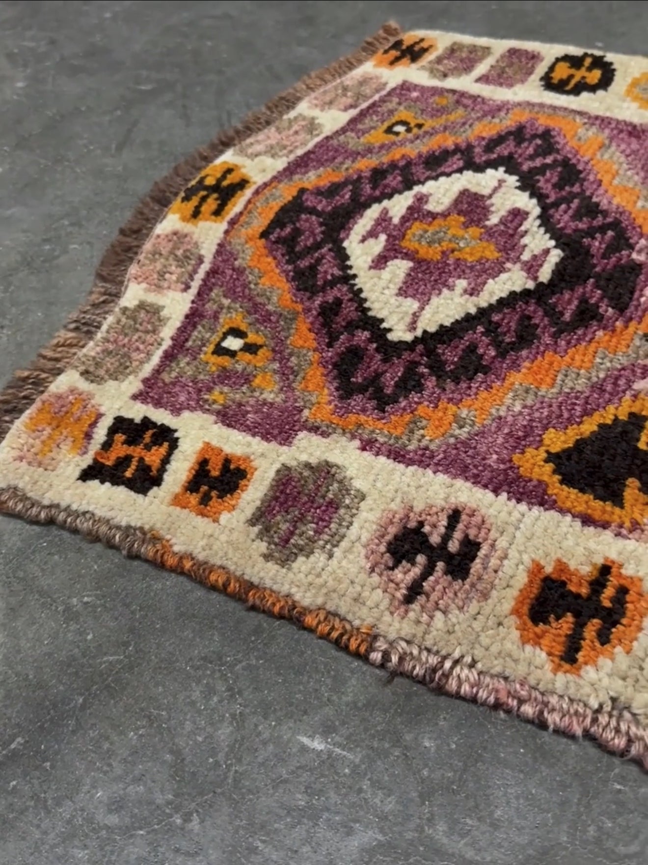 Vintage Turkish Yastik mini rug with earth colors mauve-purple, taupe, and burnt orange. Handmade woxol, 2x3 feet. One-of-a-kind rug from Indigo Rugs, the best rug shop in the San Francisco Bay Area (Burlingame, CA). Free shipping included.