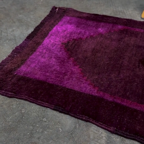 Turkish overdyed mini rug in plum, aubergine, and magenta purple with a shadowed black medallion. Hand-knotted wool, 19x38 inches. One-of-a-kind rug from Indigo Rugs in Burlingame, the best rug shop in the San Francisco Bay Area. Free shipping included.