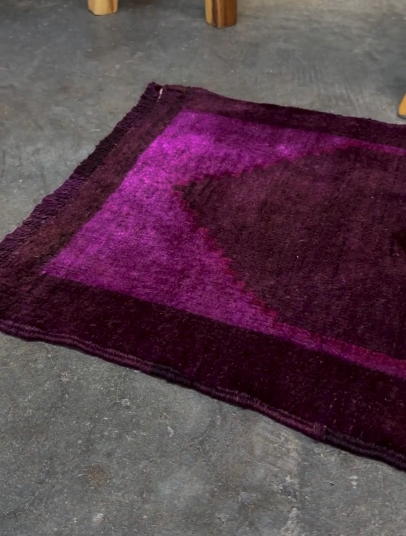 Turkish overdyed mini rug in plum, aubergine, and magenta purple with a shadowed black medallion. Hand-knotted wool, 19x38 inches. One-of-a-kind rug from Indigo Rugs in Burlingame, the best rug shop in the San Francisco Bay Area. Free shipping included.