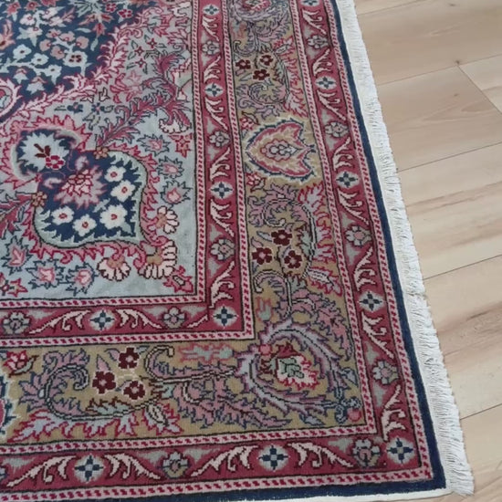 Blue vintage Turkish rug with deep blue field,  floral medallion, handmade wool 7x9 from Indigo Rugs Burlingame Bay Area.
