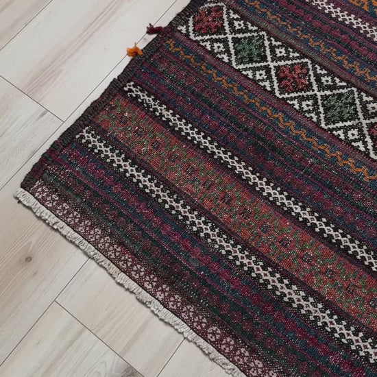 Vintage Persian tribal kilim rug with geometric horizontal bands, brick red, indigo blue, orange, decorative side tassels, handmade wool flatweave 5x6 from Indigo Rugs Burlingame Bay Area.