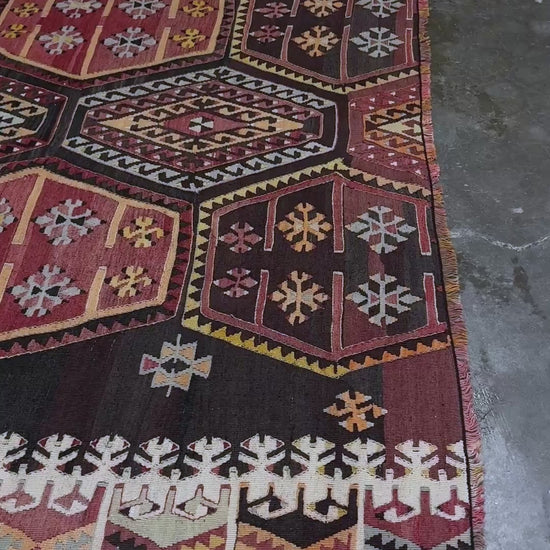 Vintage Sarkisla Turkish kilim rug 6x9 with deep brown field and geometric medallions in madder red, camel, and ivory tones — handmade Anatolian flatweave carpet