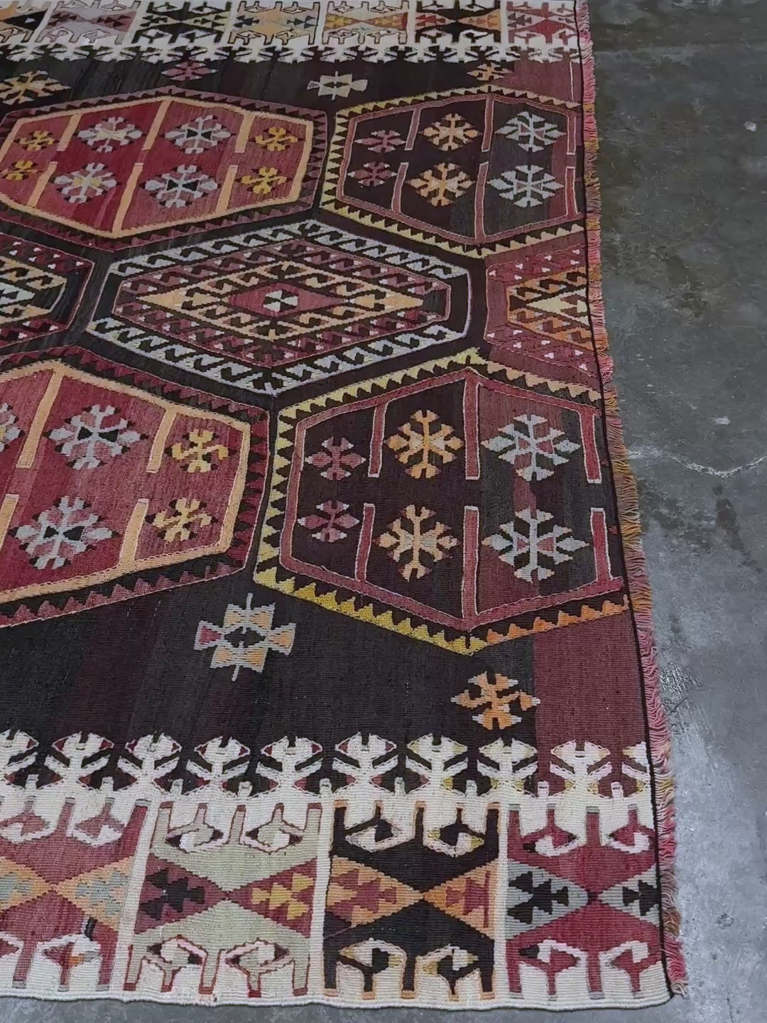 Vintage Sarkisla Turkish kilim rug 6x9 with deep brown field and geometric medallions in madder red, camel, and ivory tones — handmade Anatolian flatweave carpet