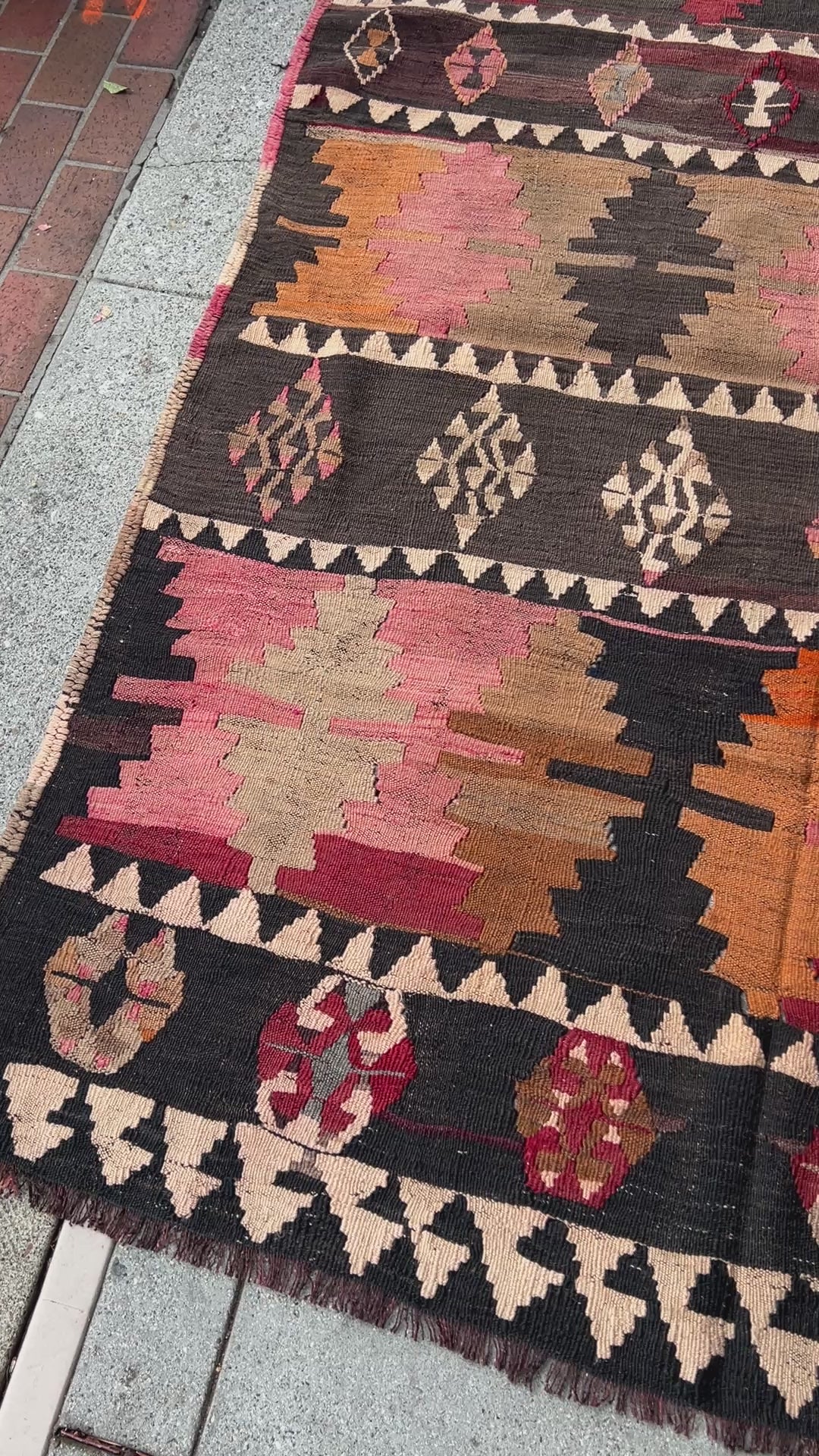 5x7 Kurdish Kilim rug from Eastern Turkey in slitweave technique, featuring bold geometric patterns in red, pink, and earthy tones. Offered by the best Kilim rug store in the San Francisco Bay Area, with free shipping to the US and Canada. A perfect gift idea for this season.