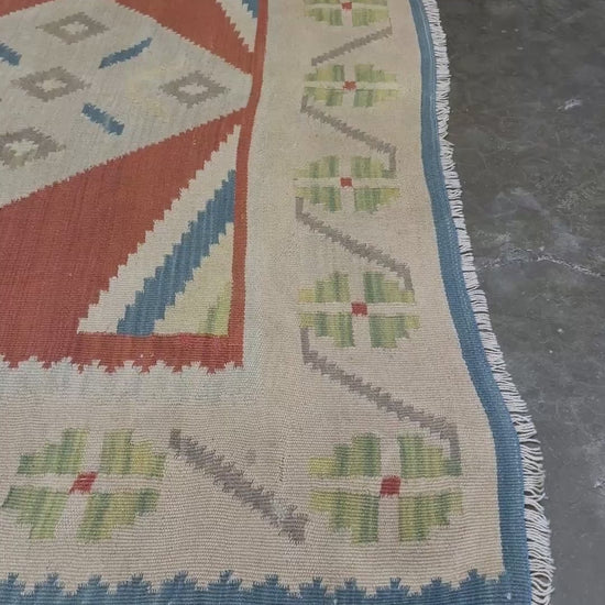 Vintage Turkish Malatya kilim rug with coral red field and diamond medallions, handwoven Anatolian flatweave 5x8 geometric wool rug