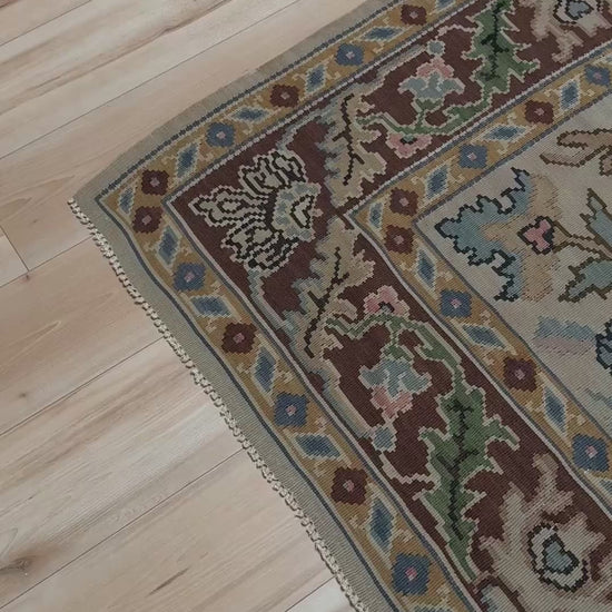 Handmade square 8x9 vintage Balkan floral kilim flatweave rug with light parchment field and vine-and-blossom design in dusty blue, rose, and sage tones.