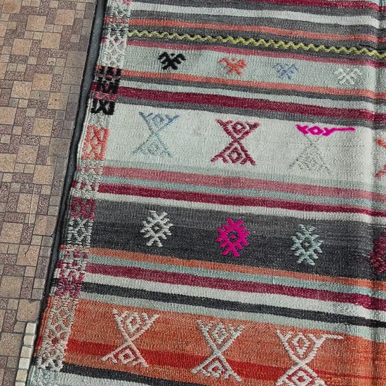 Vintage Turkish striped kilim rug, 4x6, with tribal motifs in charcoal, ivory, sky blue, coral, and red bands.