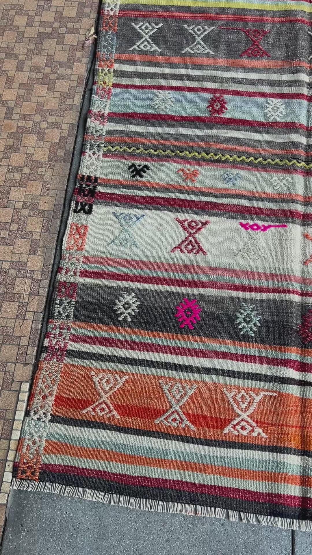 Vintage Turkish striped kilim rug, 4x6, with tribal motifs in charcoal, ivory, sky blue, coral, and red bands.