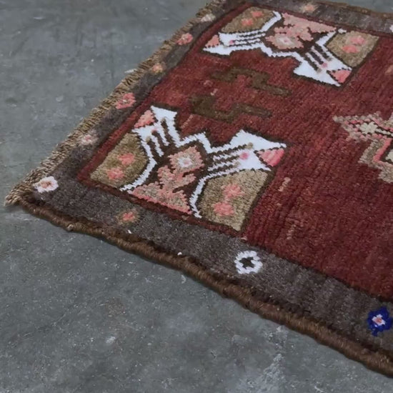 Vintage Turkish Yastik mini rug in chestnut brown with espresso outlines, camel-brown medallion, ivory highlights, muted blush and turquoise floral accents. Hand-knotted wool, 19x37 inches. One-of-a-kind vintage piece from the best rug shop in the San Francisco Bay Area, Indigo Rugs in Burlingame, CA. Free shipping included.