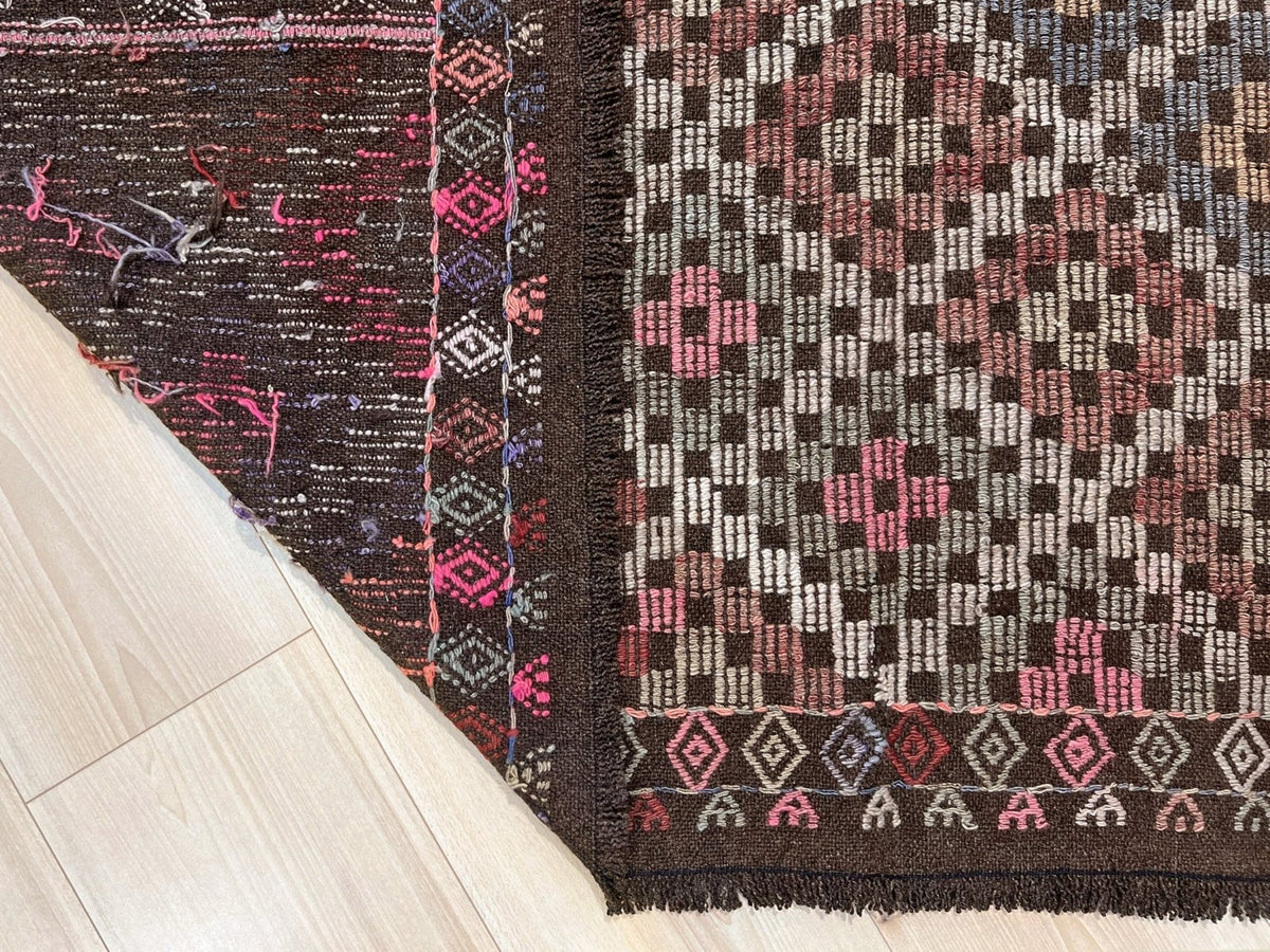 Patterned rug with geometric design on a plain background. Earthy Vintage Turkish cicim kilim rug, 5x7 Anatolian flatweave with embroidered geometric motifs in brown, ivory, dusty rose, and slate blue