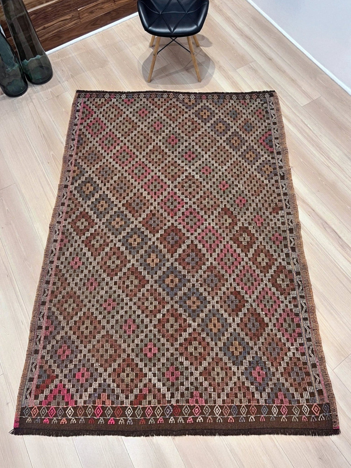 Patterned rug with geometric design on a plain background. Earthy Vintage Turkish cicim kilim rug, 5x7 Anatolian flatweave with embroidered geometric motifs in brown, ivory, dusty rose, and slate blue