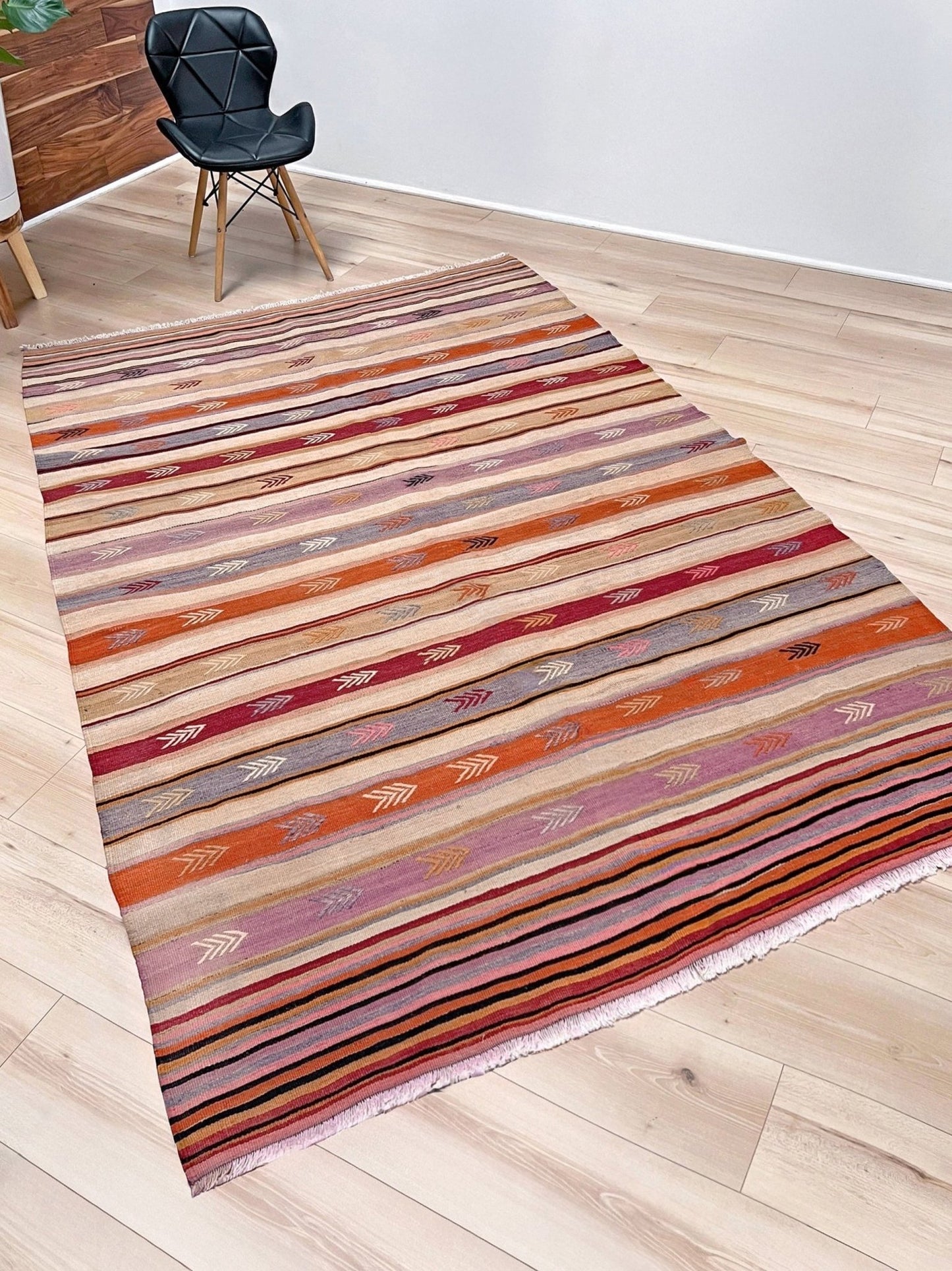 Vintage Anatolian kilim rug, 6x8 with horizontal arrow motifs in sun-washed tones.