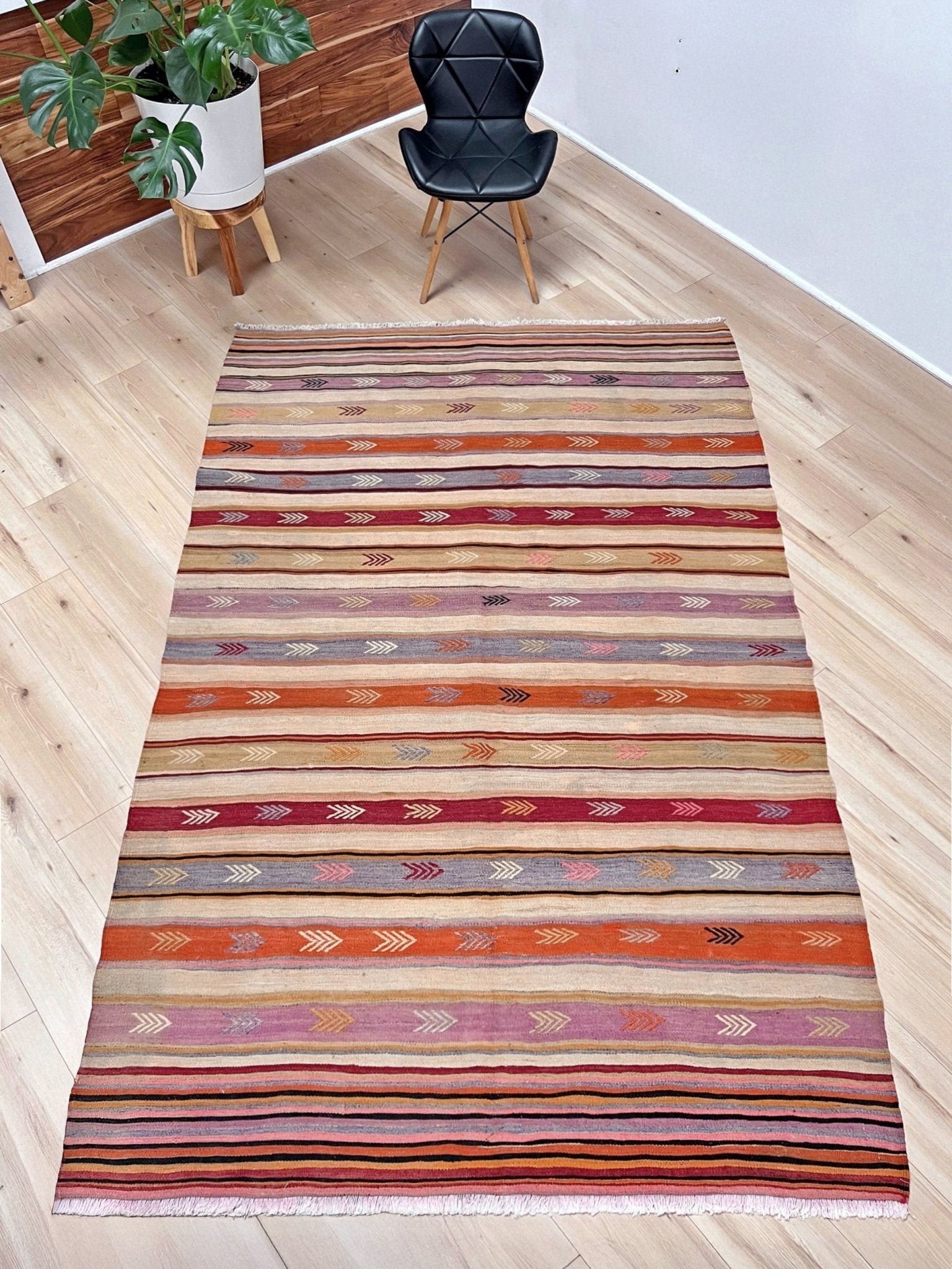 Vintage Anatolian kilim rug, 6x8 with horizontal arrow motifs in sun-washed tones.