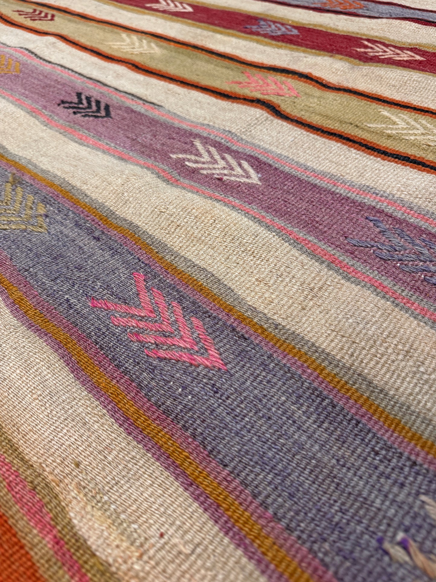 Vintage Anatolian kilim rug, 6x8 with horizontal arrow motifs in sun-washed tones.