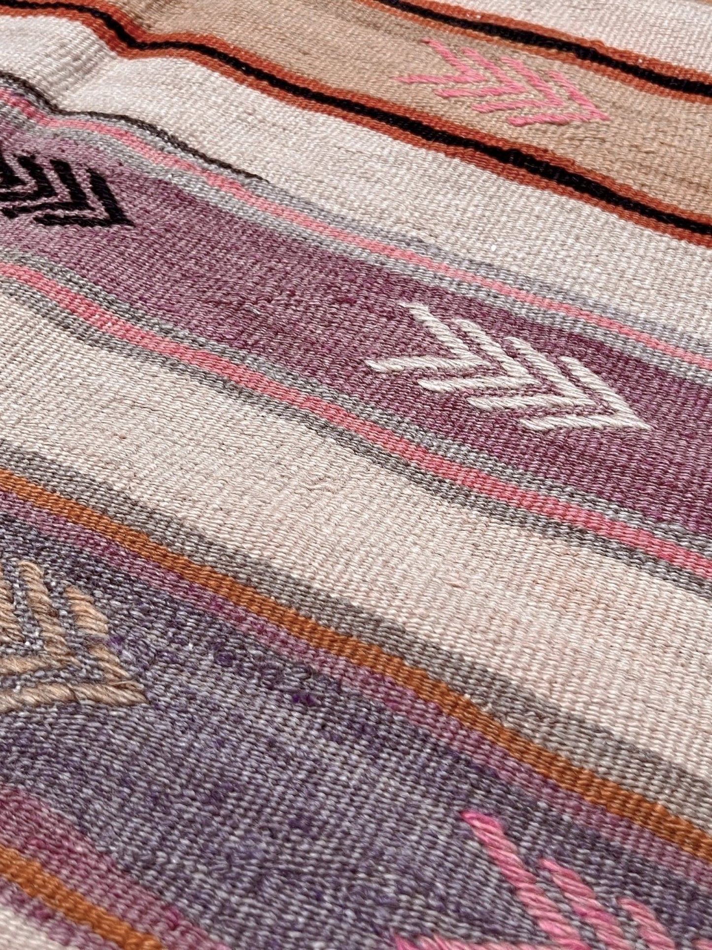Vintage Anatolian kilim rug, 6x8 with horizontal arrow motifs in sun-washed tones.