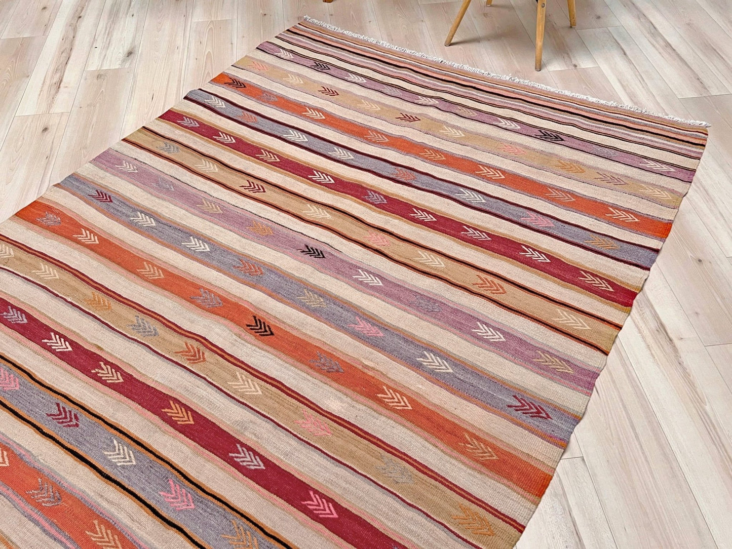 Vintage Anatolian kilim rug, 6x8 with horizontal arrow motifs in sun-washed tones.