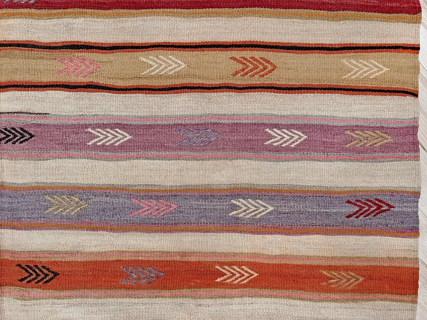 Vintage Anatolian kilim rug, 6x8 with horizontal arrow motifs in sun-washed tones.