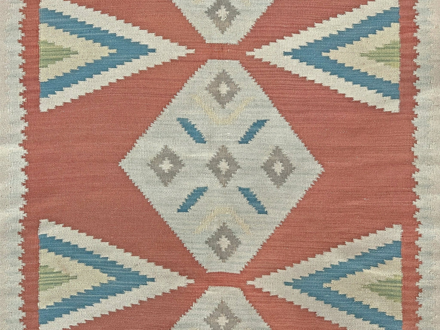 Geometric patterned rug with red, blue, and beige colors on a beige background. Vintage Turkish Malatya kilim rug with coral red field and diamond medallions, handwoven Anatolian flatweave 5x8 geometric wool rug