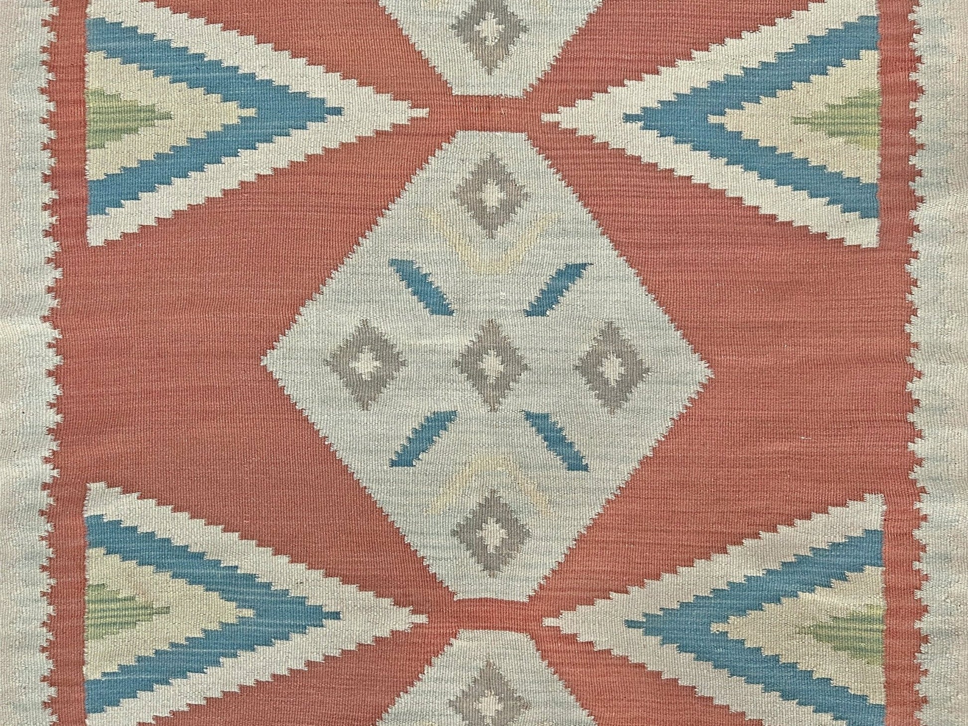 Geometric patterned rug with red, blue, and beige colors on a beige background. Vintage Turkish Malatya kilim rug with coral red field and diamond medallions, handwoven Anatolian flatweave 5x8 geometric wool rug