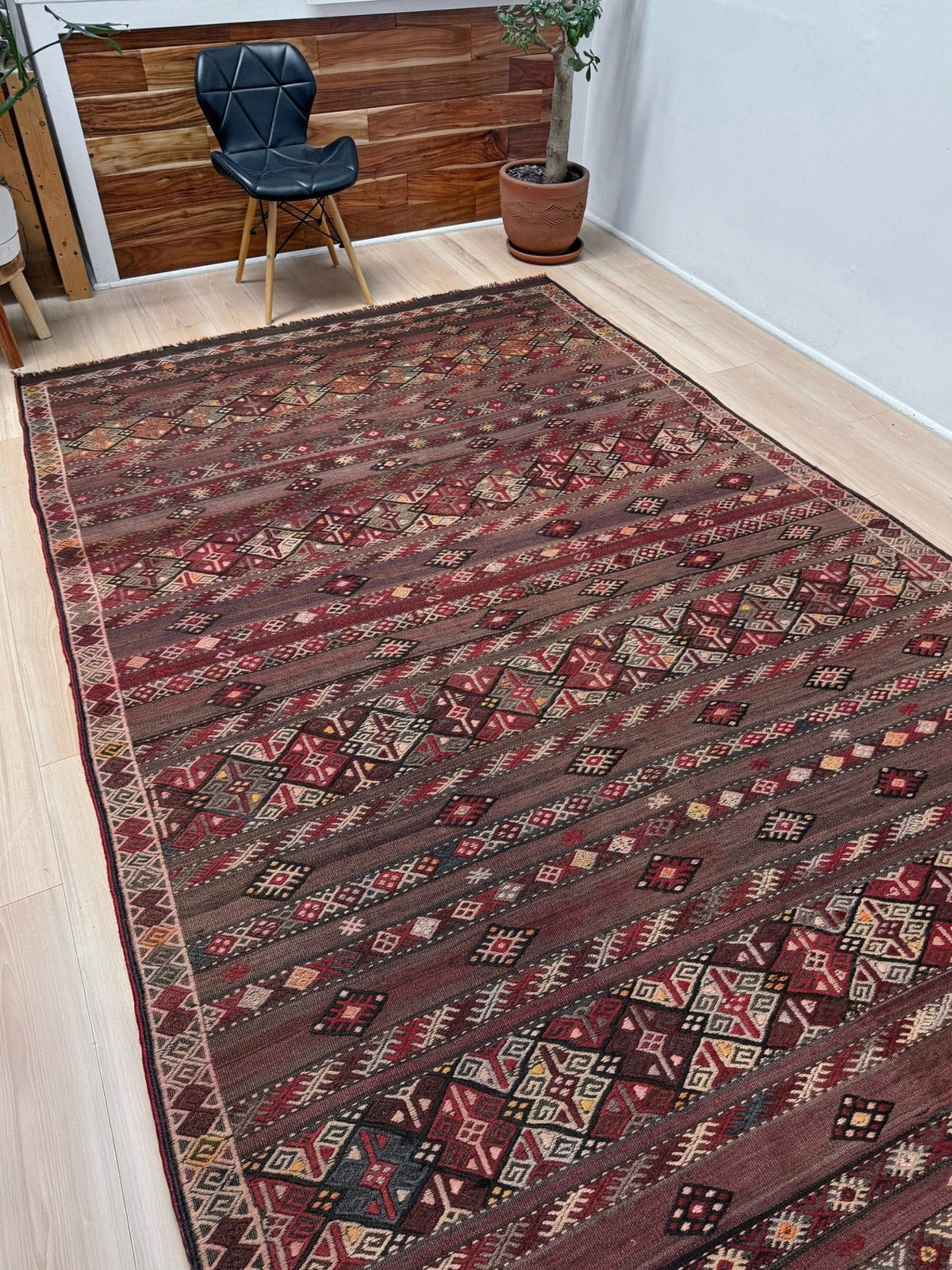 Traditional patterned rug with geometric design. 7x13 eggplant purple oxblood red Vintage 1940s Kurdish Kars kilim rug with tribal motifs for long living rooms, hallways, great rooms, and layered interiors. From Indigo Rugs, Burlingame CA.