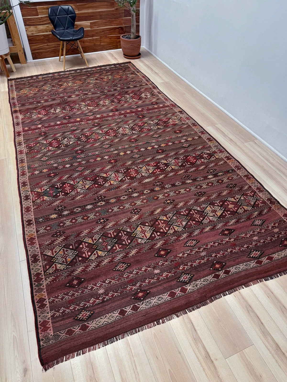 Traditional patterned rug with geometric design. 7x13 eggplant purple oxblood red Vintage 1940s Kurdish Kars kilim rug with tribal motifs for long living rooms, hallways, great rooms, and layered interiors. From Indigo Rugs, Burlingame CA.