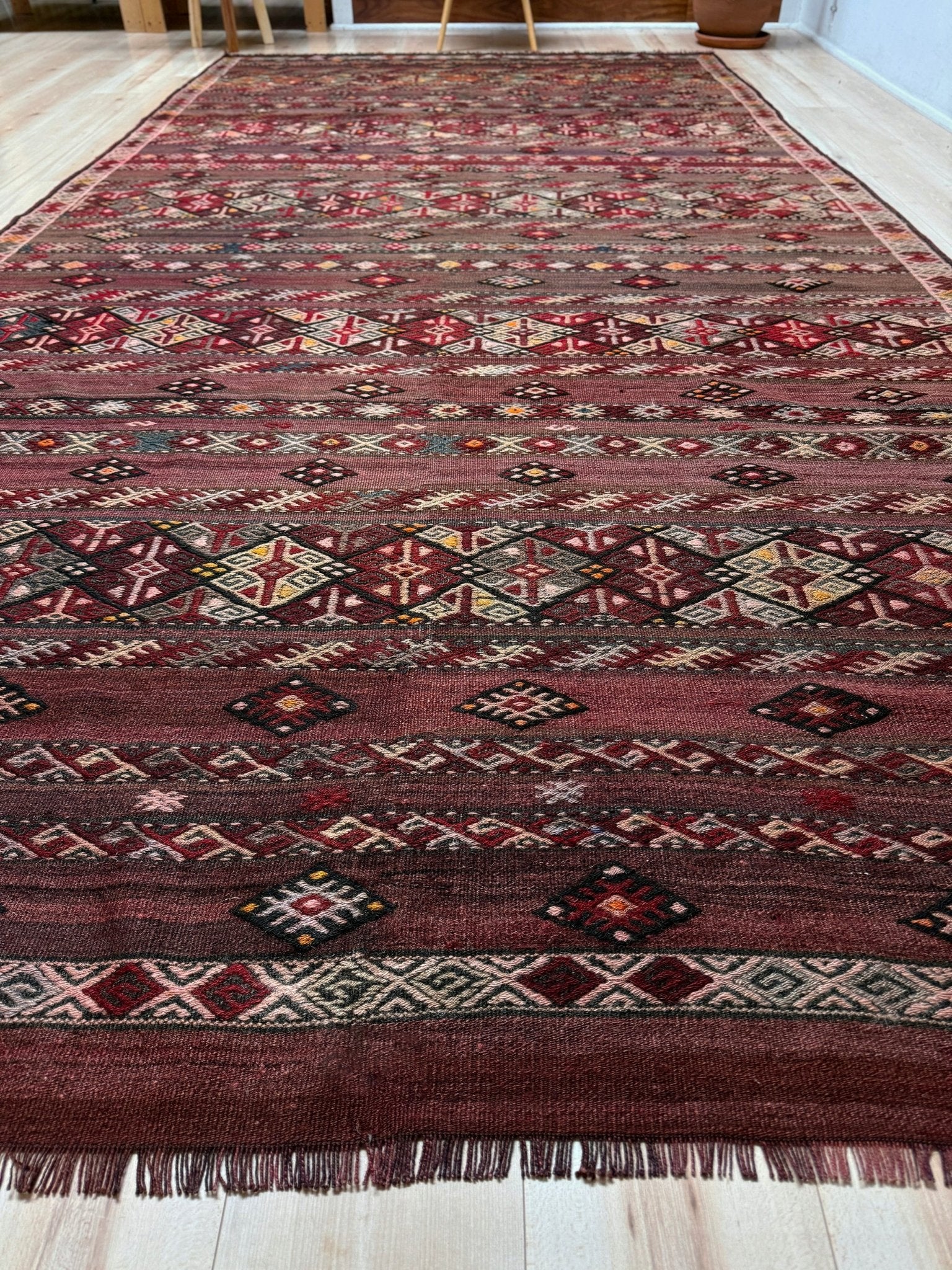 7x13 eggplant purple oxblood red Vintage 1940s Kurdish Kars kilim rug with tribal motifs. Handmade wool flatweave rug — perfect for long living rooms, hallways, great rooms, and layered interiors. From Indigo Rugs, Burlingame CA. Free shipping.