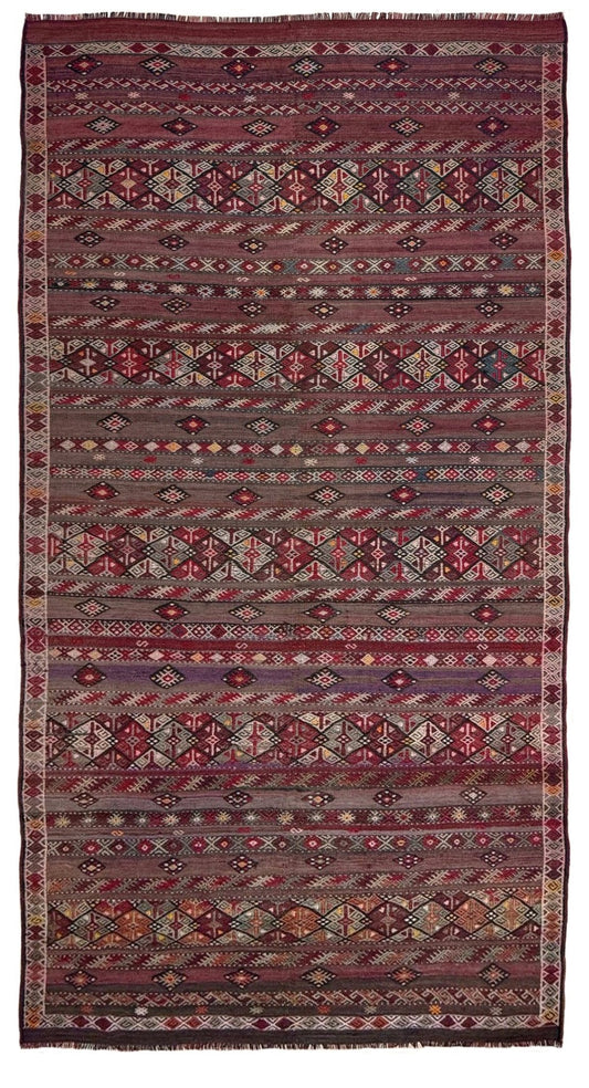 Traditional patterned rug with geometric design. 7x13 eggplant purple oxblood red Vintage 1940s Kurdish Kars kilim rug with tribal motifs for long living rooms, hallways, great rooms, and layered interiors. From Indigo Rugs, Burlingame CA.