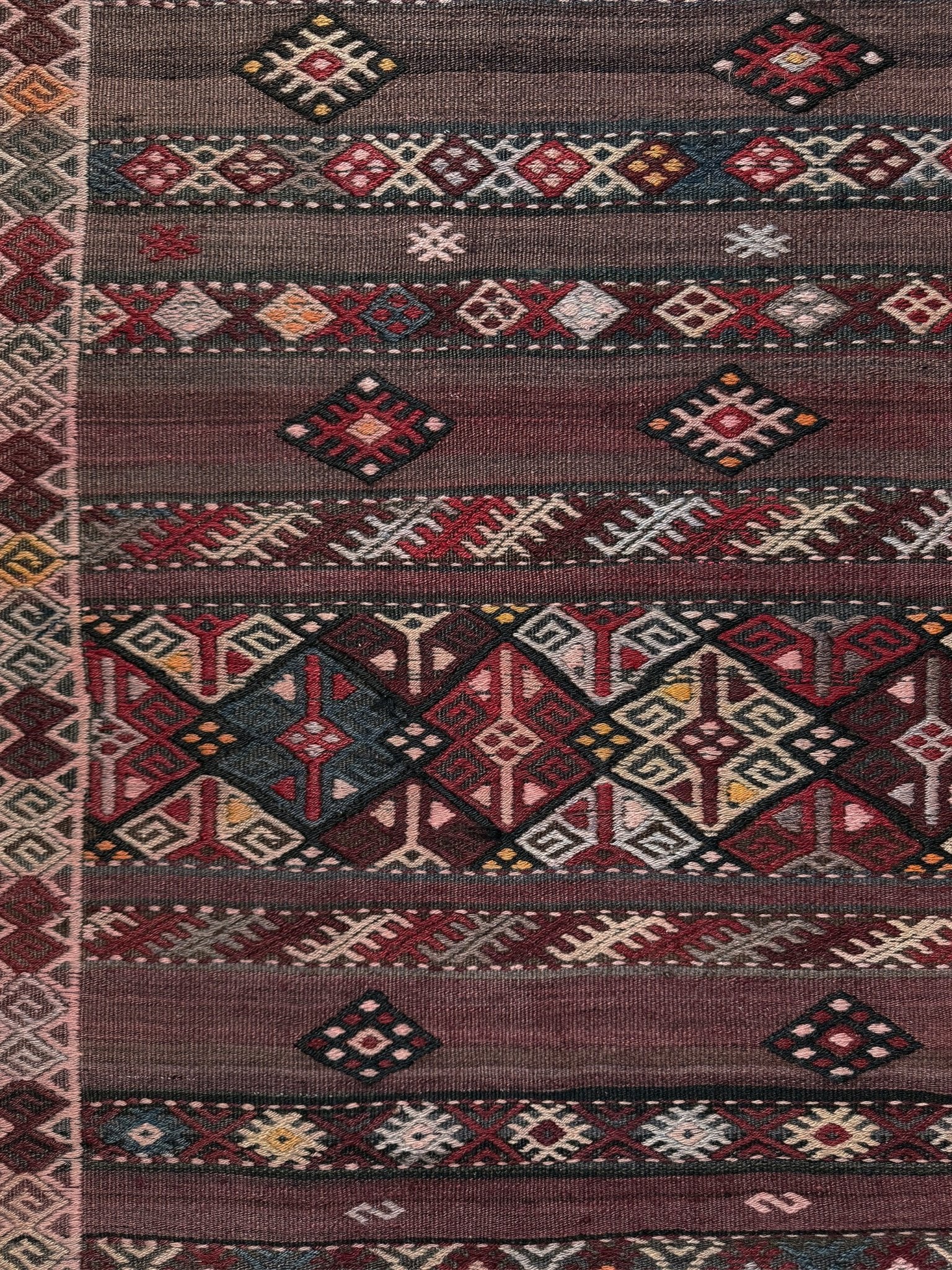 7x13 eggplant purple oxblood red Vintage 1940s Kurdish Kars kilim rug with tribal motifs. Handmade wool flatweave rug — perfect for long living rooms, hallways, great rooms, and layered interiors. From Indigo Rugs, Burlingame CA. Free shipping.
