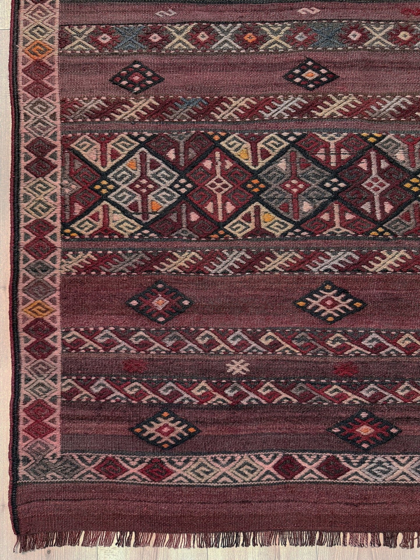 7x13 eggplant purple oxblood red Vintage 1940s Kurdish Kars kilim rug with tribal motifs. Handmade wool flatweave rug — perfect for long living rooms, hallways, great rooms, and layered interiors. From Indigo Rugs, Burlingame CA. Free shipping.