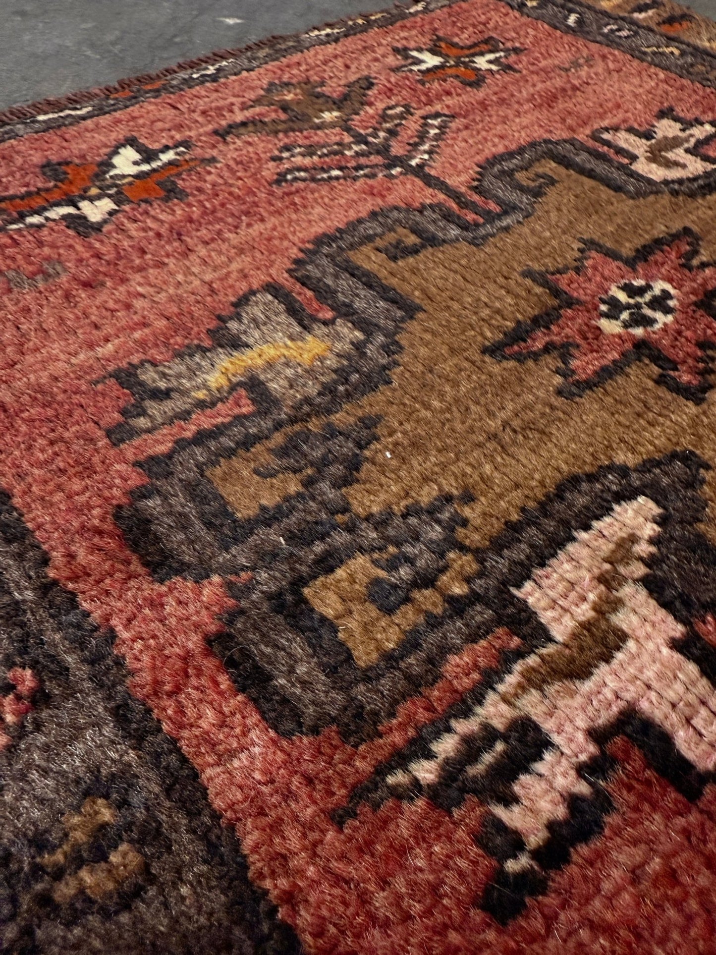 Vintage Turkish Yastik rug with a terracotta field, olive-brown medallions. Hand-knotted wool, 24x34 inches. Perfect accent  mini rug kitchen, entry, bathroom, study.  One-of-a-kind rug from Indigo Rugs in Burlingame, the best rug shop in the San Francisco Bay Area. Free shipping included.