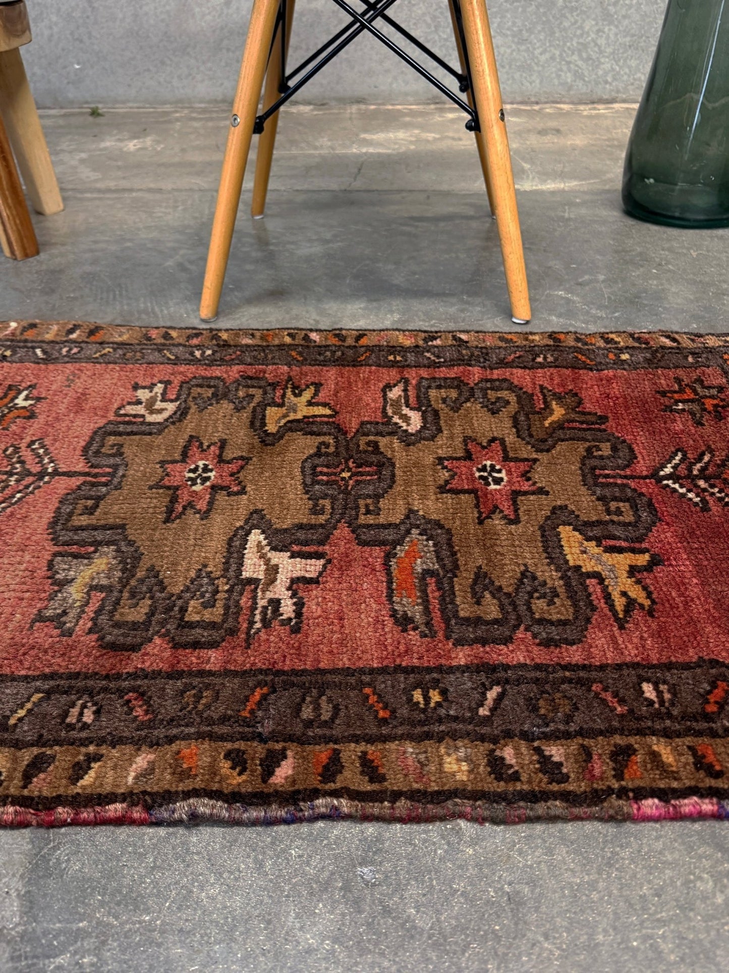 Vintage Turkish Yastik rug with a terracotta field, olive-brown medallions. Hand-knotted wool, 24x34 inches. Perfect accent  mini rug kitchen, entry, bathroom, study.  One-of-a-kind rug from Indigo Rugs in Burlingame, the best rug shop in the San Francisco Bay Area. Free shipping included.