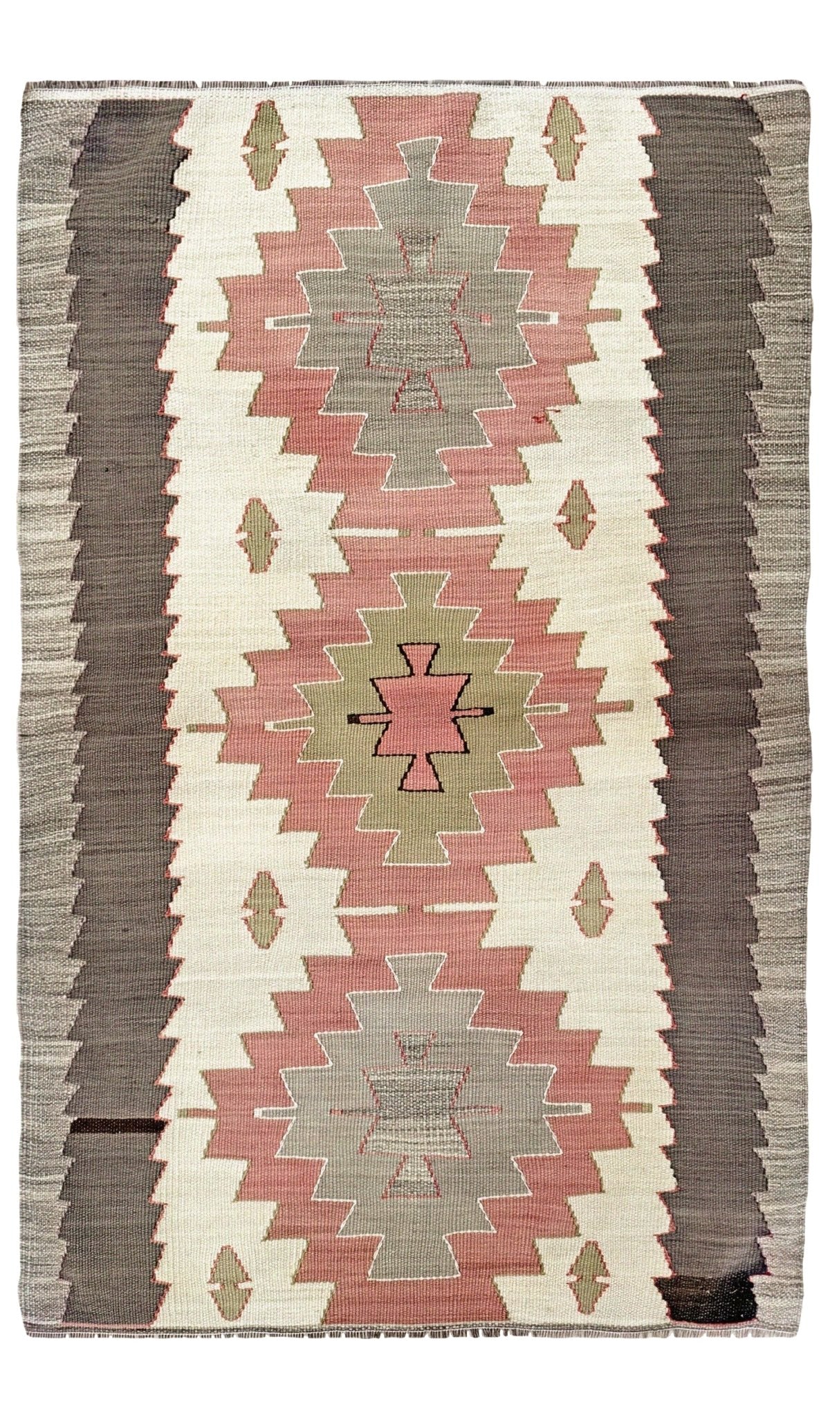 A flat-laid woven rug with a Southwestern geometric pattern, featuring vertical stripes and diamond medallions in dusty pink, olive green, taupe, and cream.